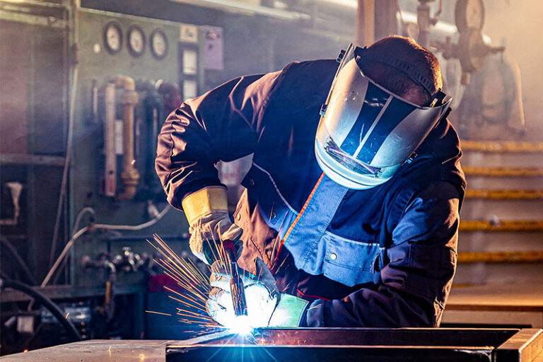 A welder in safety gear at work