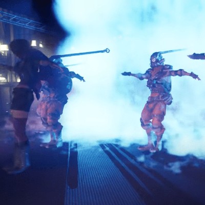 a smoky street with several humanoid figures