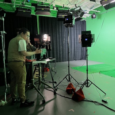 a film team looking towards a greenscreen